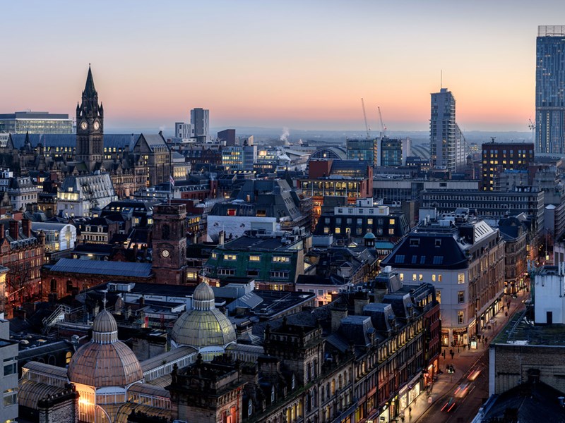 City skyline image at night of Manchester