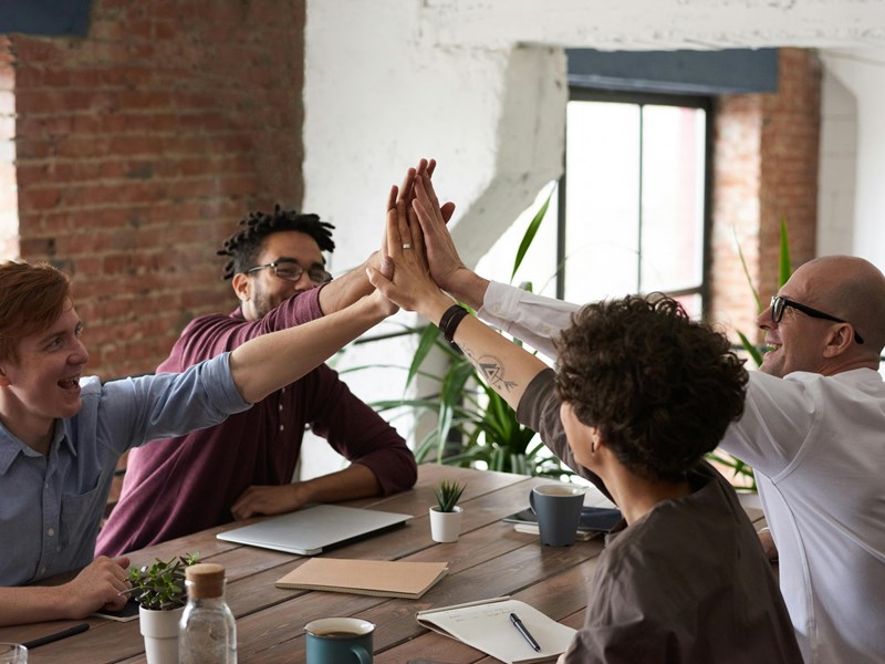 A group of people Hi-Fiving each other