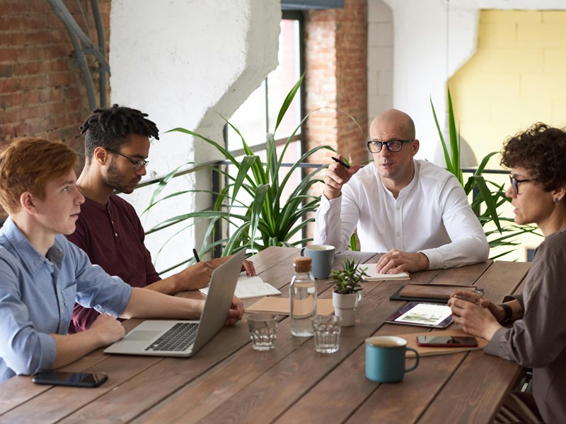 A team sat round a table collaborating